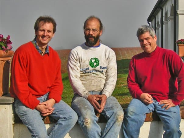 Luca, Mike and Craig sitting on a fence on some farmland