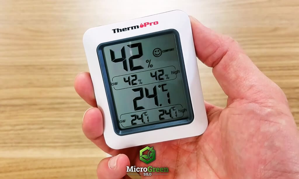 Hand holding a ThermoPro TP50 Digital Hygrometer