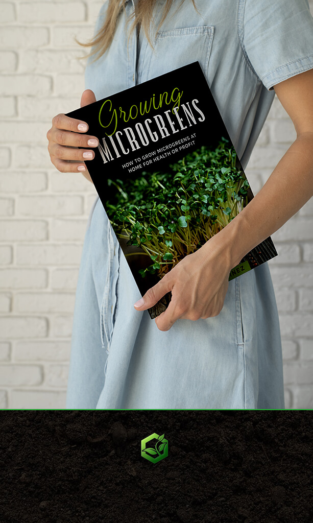 Woman holding a book titled growing microgreens