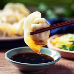 Close up fresh boiled dumplings . Chinese food on rustic old vintage wooden background.